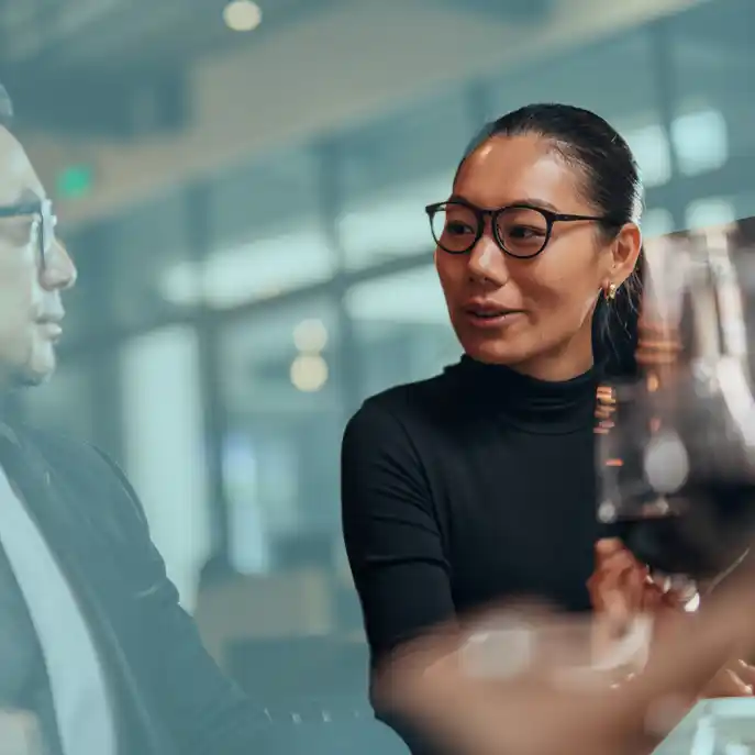 content strategy australia copy.jpg Oriental woman with glasses at a dinner table looking to colleagues. She is the only one not with a blue gradient over her.