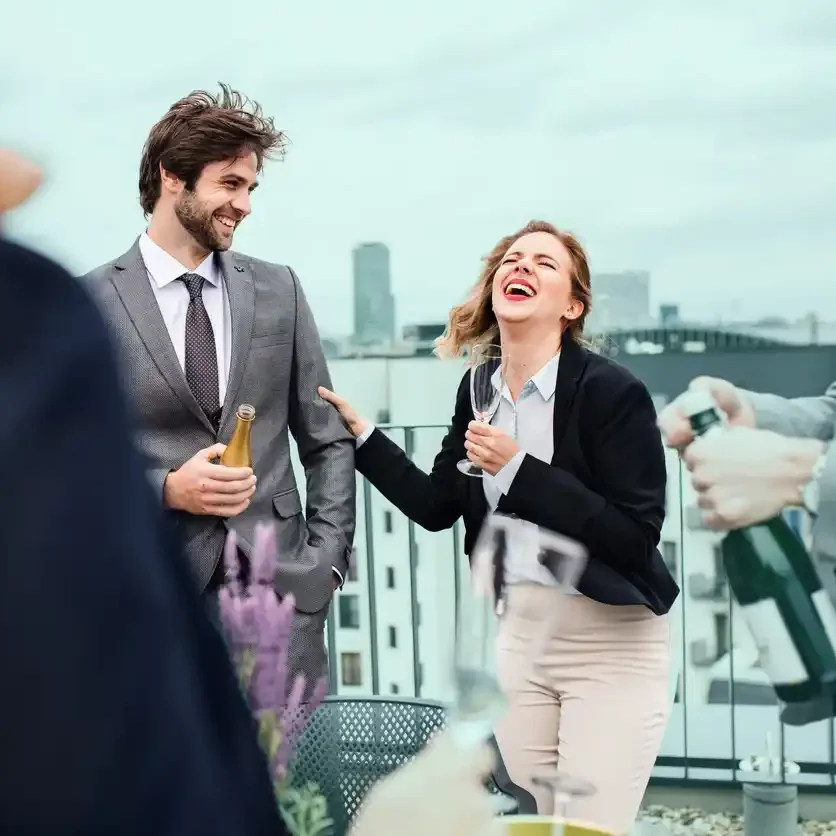 copywriting pricing.jpeg Copywriters laughing on rooftop bar in Perth with champagne in hand.