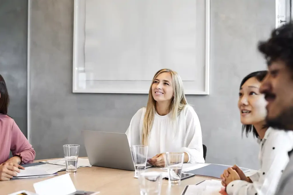 Female mortgage broker in a meeting with marketers in an office setting