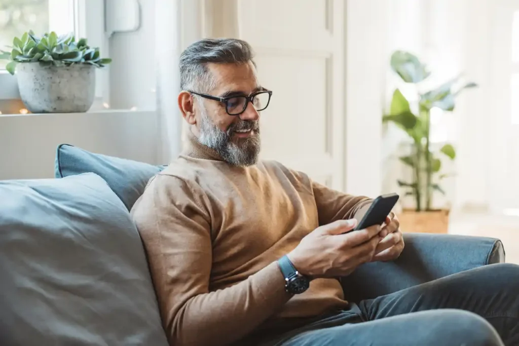 Mortgage broking customer on mobile on couch.