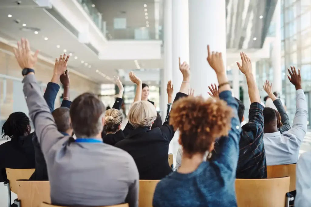 a group of mortgage brokers raising their hands